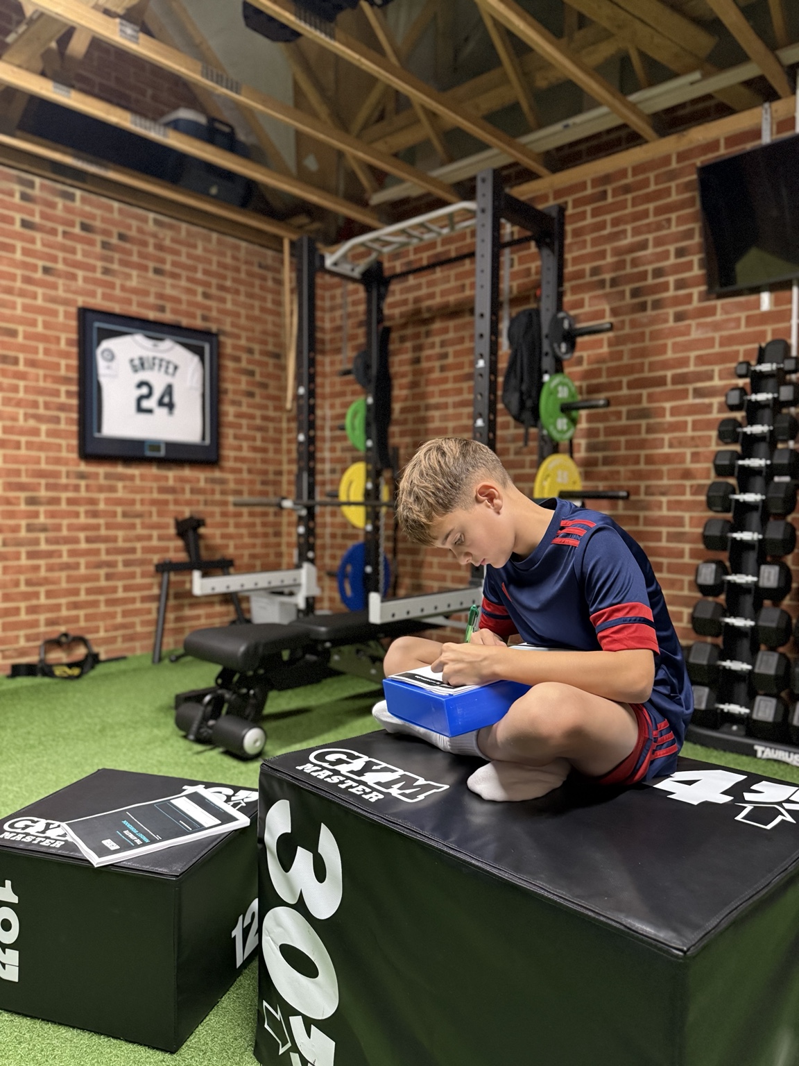 Young CuttingEdge athlete completing his development workbook after training